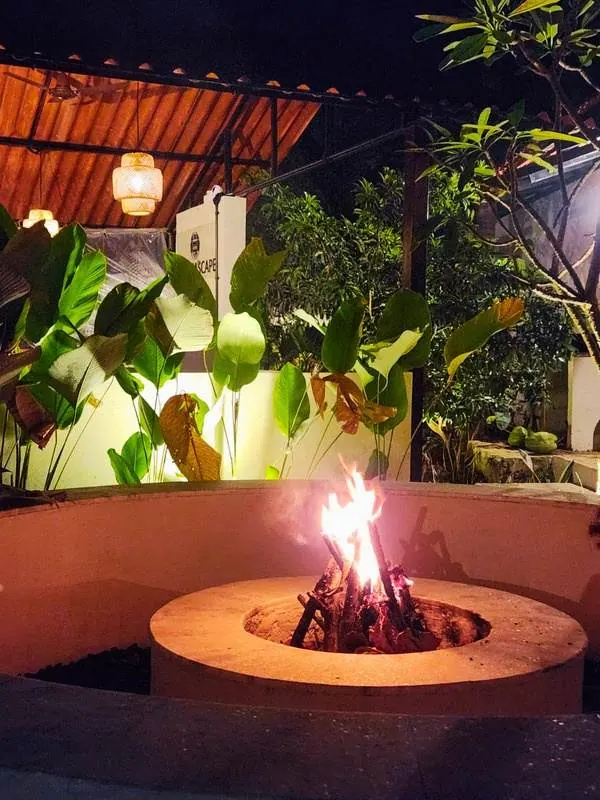 Evening bonfire at The Seascape amid tropical plants